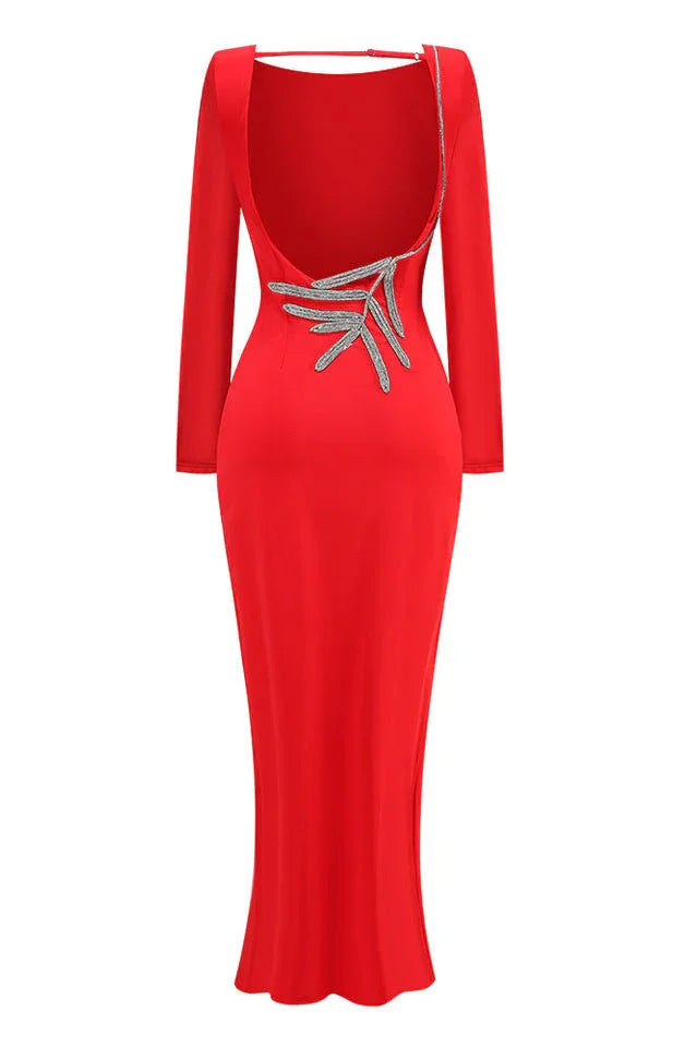 Back view of a red long sleeve sheath gown with an open back and embellishment