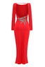 Back view of a red long sleeve sheath gown with an open back and embellishment