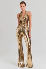 Woman wearing a gold sequined halter neck jumpsuit with wide leg pants, front view.