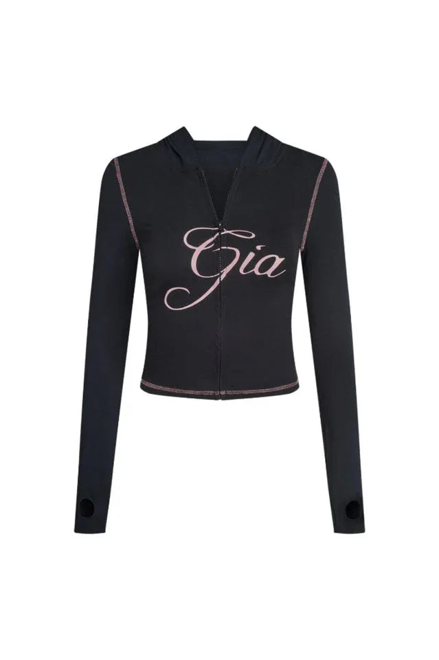 Front view of the black long-sleeve zip-up top with pink embroidery and contrast stitching.