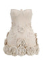 Full front view of a strapless beige mini dress with a fitted corset-style bodice. The skirt is decorated with appliqué flowers and leaves, with larger floral embellishments at the hem.