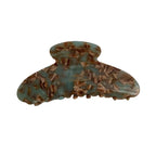 A single light blue and brown tortoiseshell patterned hair claw clip, made of acetate, with 'FRANCE Handmade' printed in gold.
