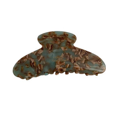 A single light blue and brown tortoiseshell patterned hair claw clip, made of acetate, with 'FRANCE Handmade' printed in gold.