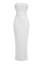 Full-length studio shot of a white strapless pearl-embellished column gown