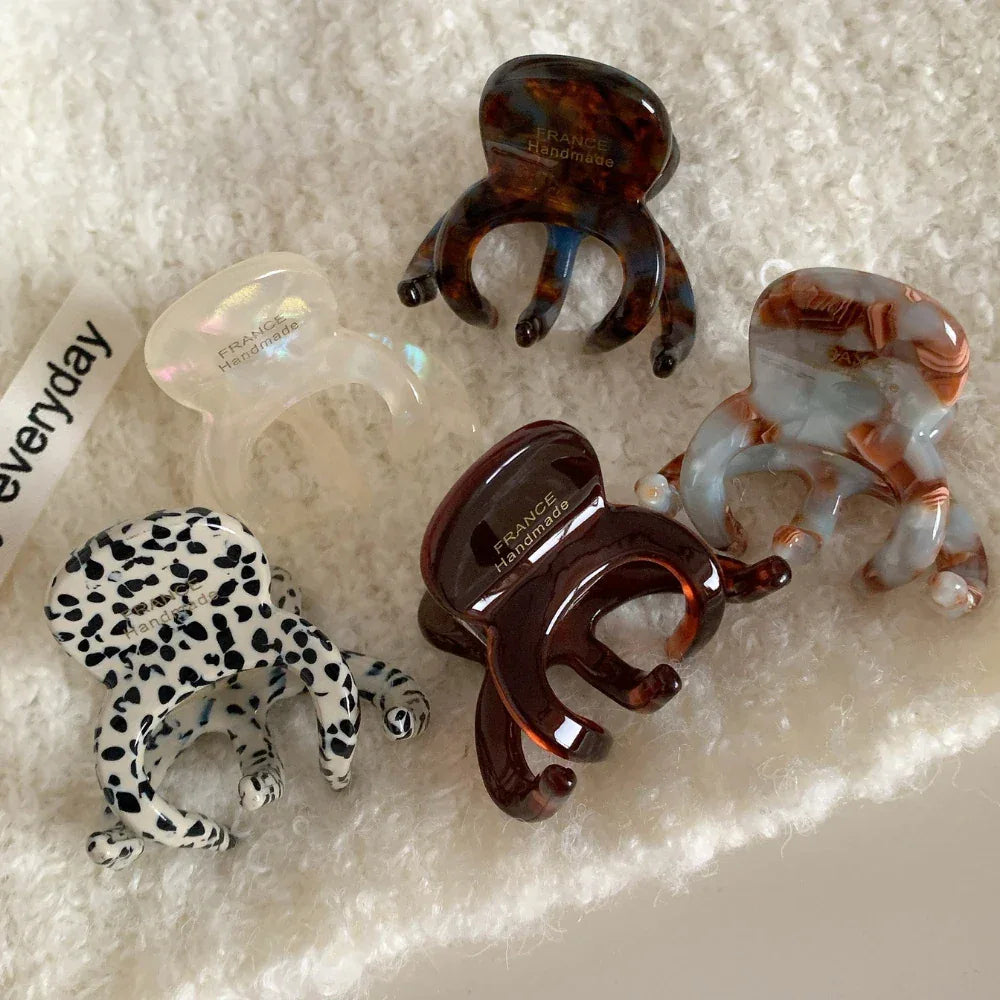 Various octopus hair clips displayed on a textured white background