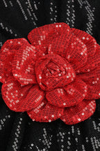 Close-up of a red sequined floral applique on a black sequined garment.
