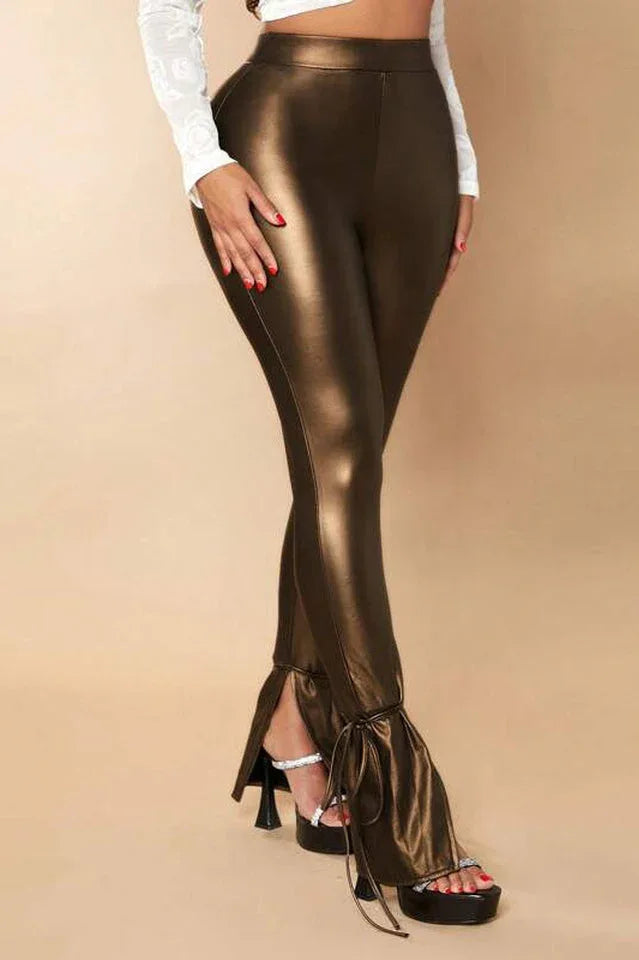 Close-up of woman's legs wearing bronze faux leather pants with split ankles