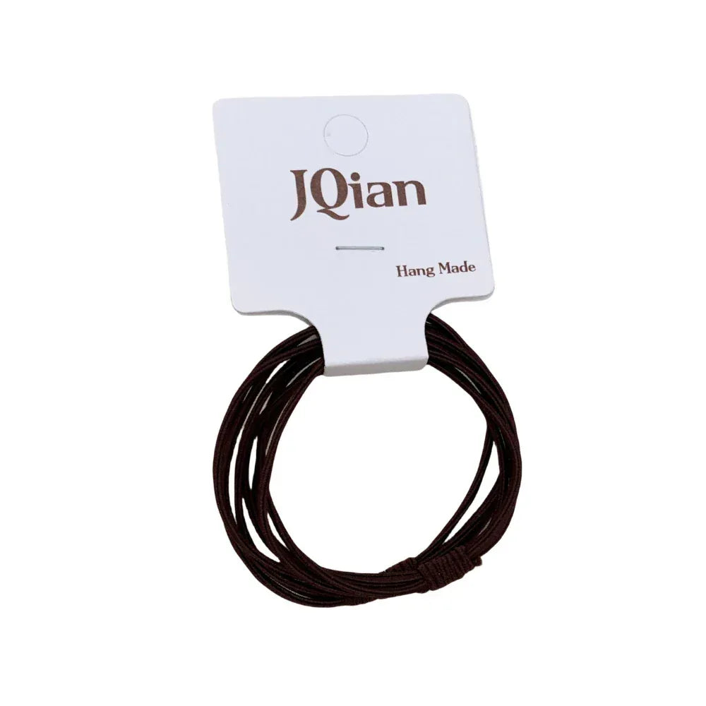 Close-up of a single brown elastic hair tie on branded cardstock.