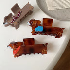 Close-up of dachshund hair claw clips with detailed scarf patterns