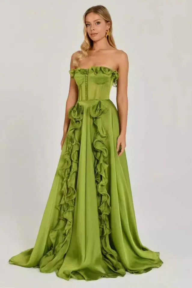 Woman in a green strapless satin gown with ruffled detailing, front view.