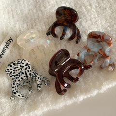 Various octopus hair clips displayed on a textured white background