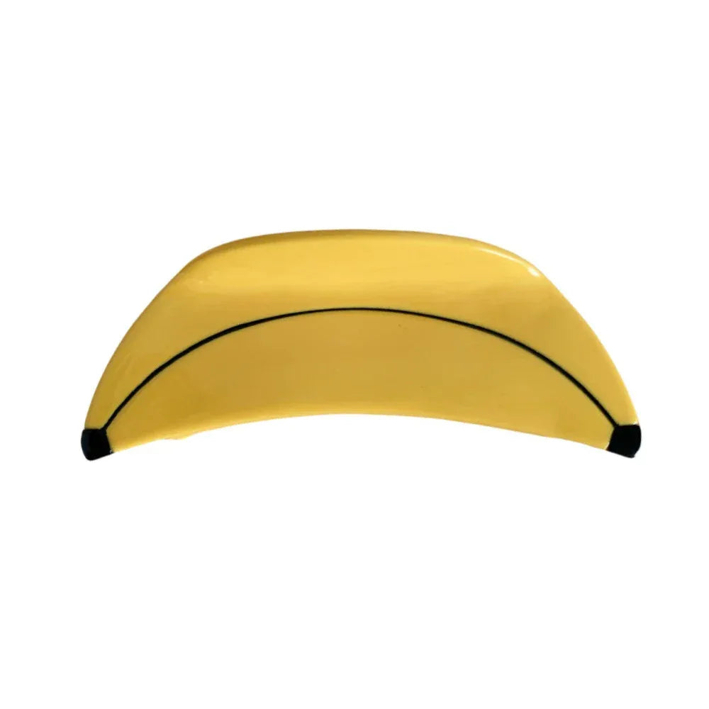 A single yellow banana-shaped hair clip with a black stripe and black tips, isolated on a white background.