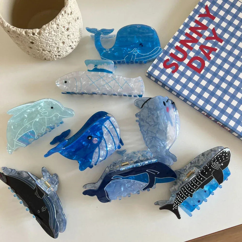 Collection of ocean-themed hair claw clips, including whales, dolphins, and crabs
