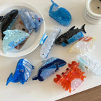 Assortment of marine animal hair clips with various colors and designs