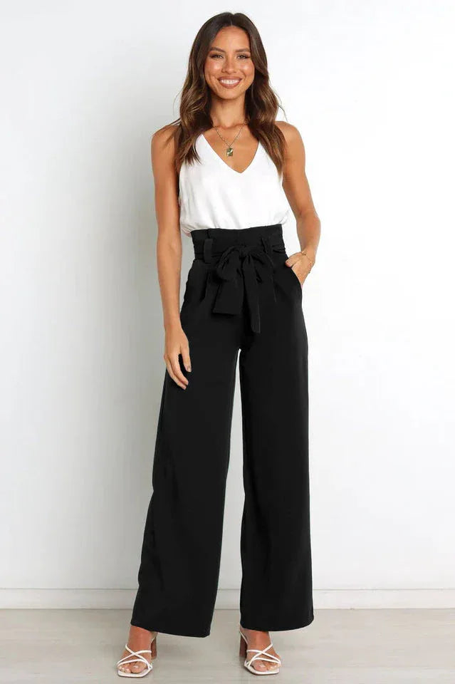 woman wearing high waist wide leg black pants with white tank top