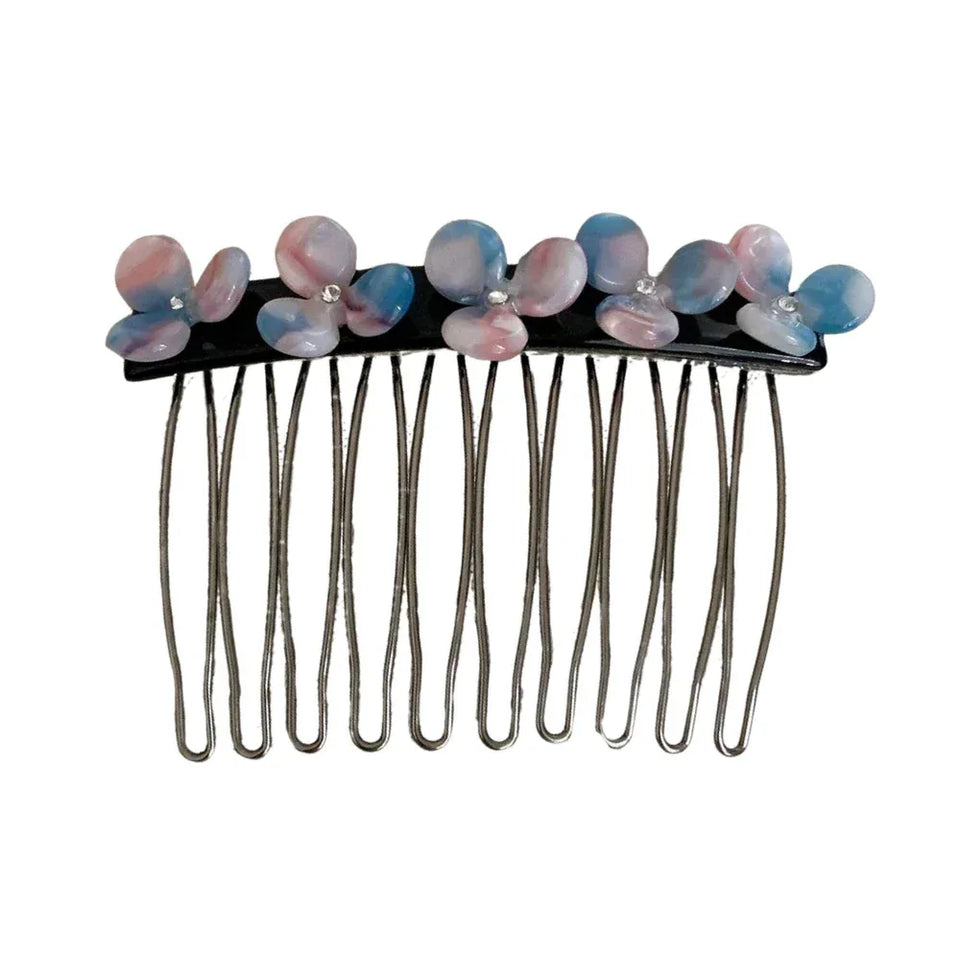Close-up of a hair comb with pink and blue floral embellishments and clear gemstones Main image