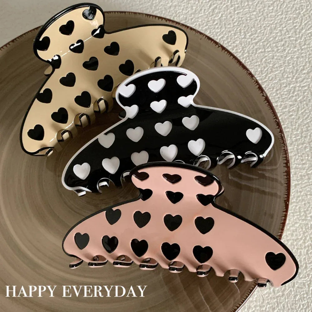 three heart pattern claw clips on a plate
