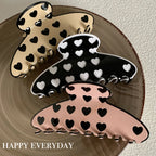 three heart pattern claw clips on a plate
