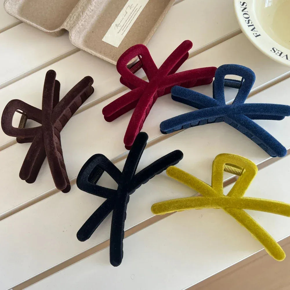 Collection of velvet interlocking hair claw clips in various colors including brown, red, blue, black, and yellow
