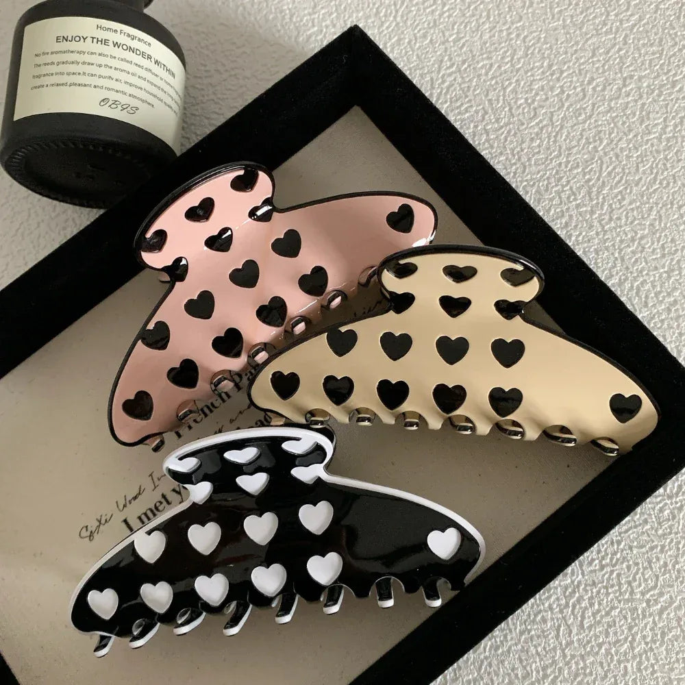 three heart pattern claw clips arranged in a frame