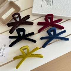 Assortment of velvet interlocking hair claw clips displayed on a white surface