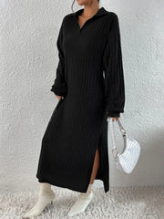 Woman wearing a black long-sleeved ribbed knit dress with a high slit and white boots, holding a white handbag.