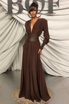 Full-length shot of a model wearing a brown V-neck maxi dress with long sleeves.