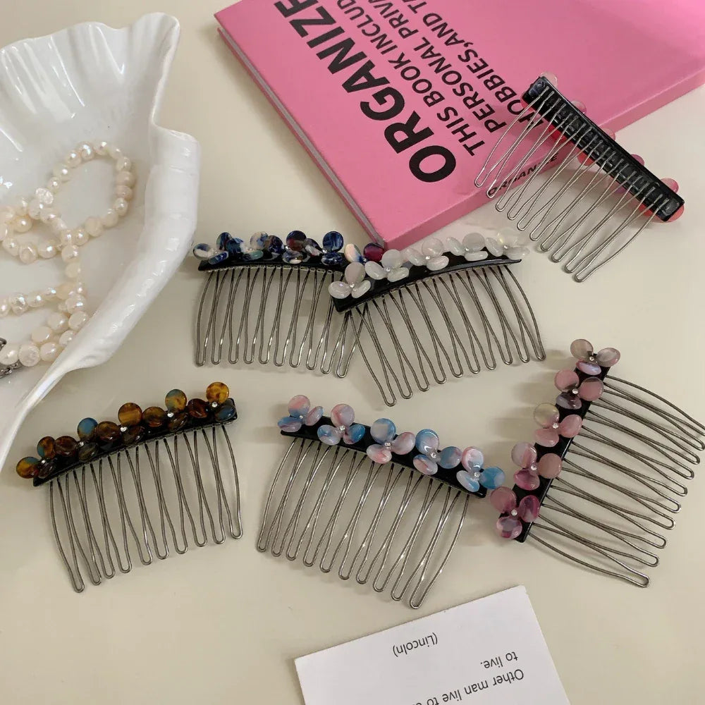 Various decorative hair combs with colorful bead flowers and gemstones scattered on a surface