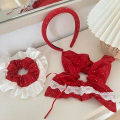 Red polka dot hair accessories laid out on a white surface