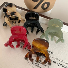 Assortment of colorful octopus hair clips arranged on a surface