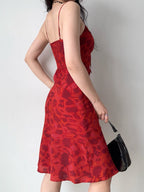Back view of a red floral print midi dress showing the smocked back panel.