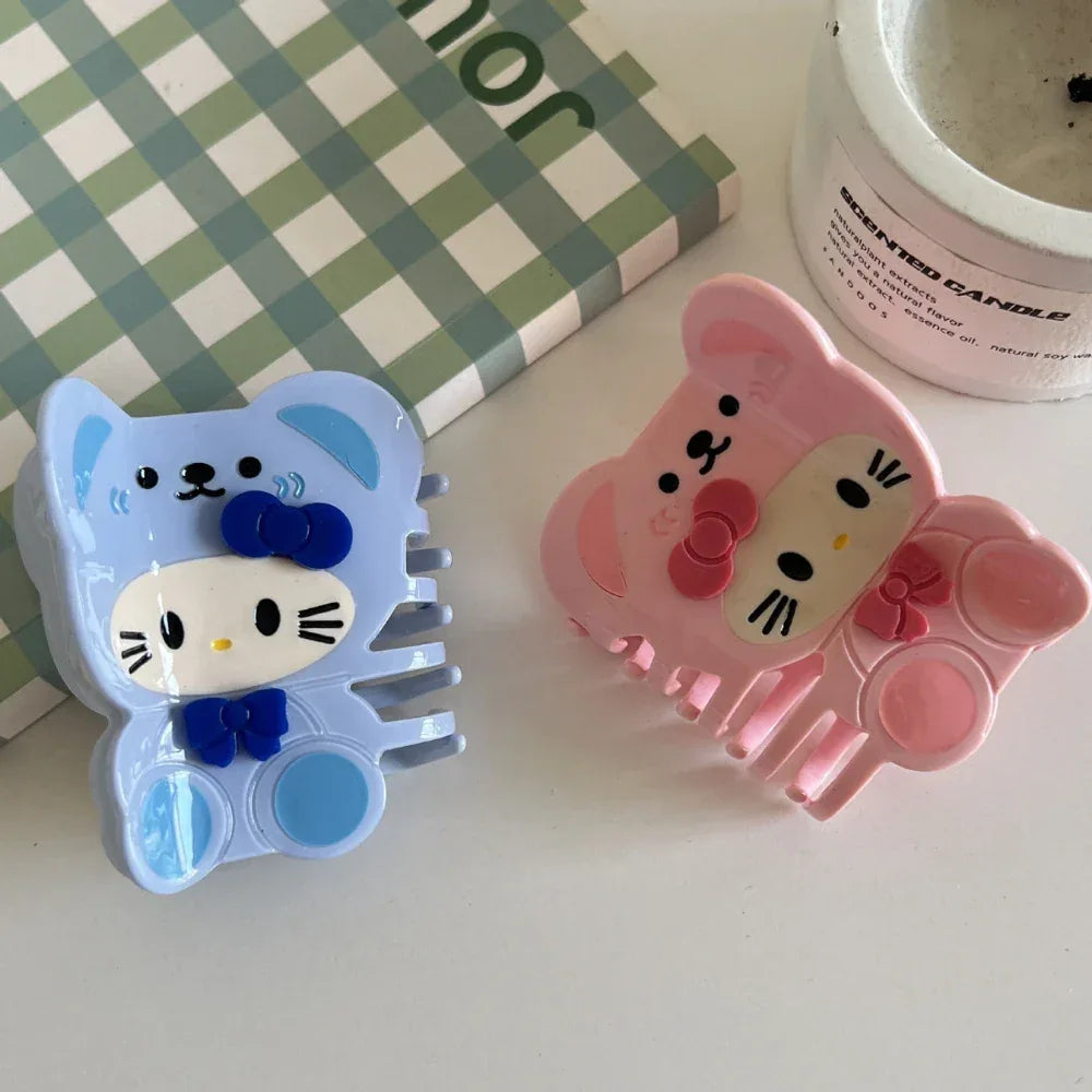 Blue and pink character hair claw clips arranged on a white surface