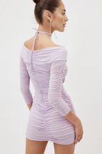 Back view of a lavender ruched mini dress with a halter tie
