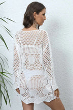 Back view of a woman wearing a white crochet knit tunic.