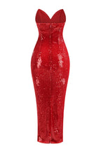 Back view of a red sequined strapless evening gown with a sweetheart neckline and a fitted column silhouette.