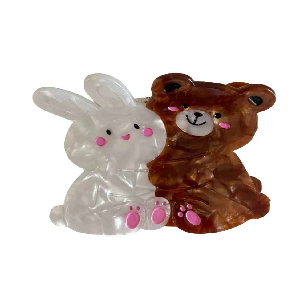 A white bunny and a brown bear hair claw clip are shown against a white background. Main image