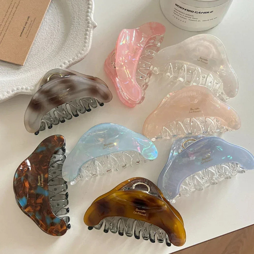 A group of stylish hair claws displayed with decorative items.