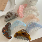 A group of stylish hair claws displayed with decorative items.