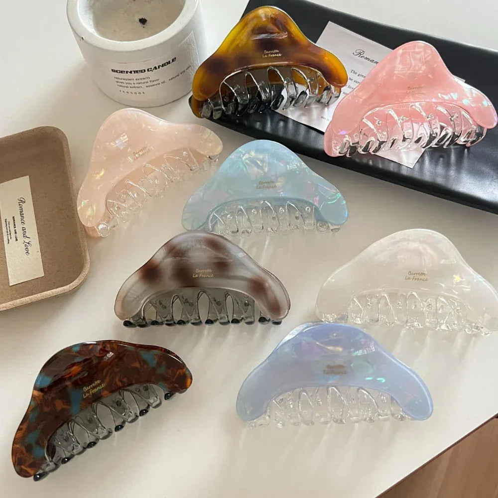 A collection of various tortoiseshell and pastel-colored hair claws.