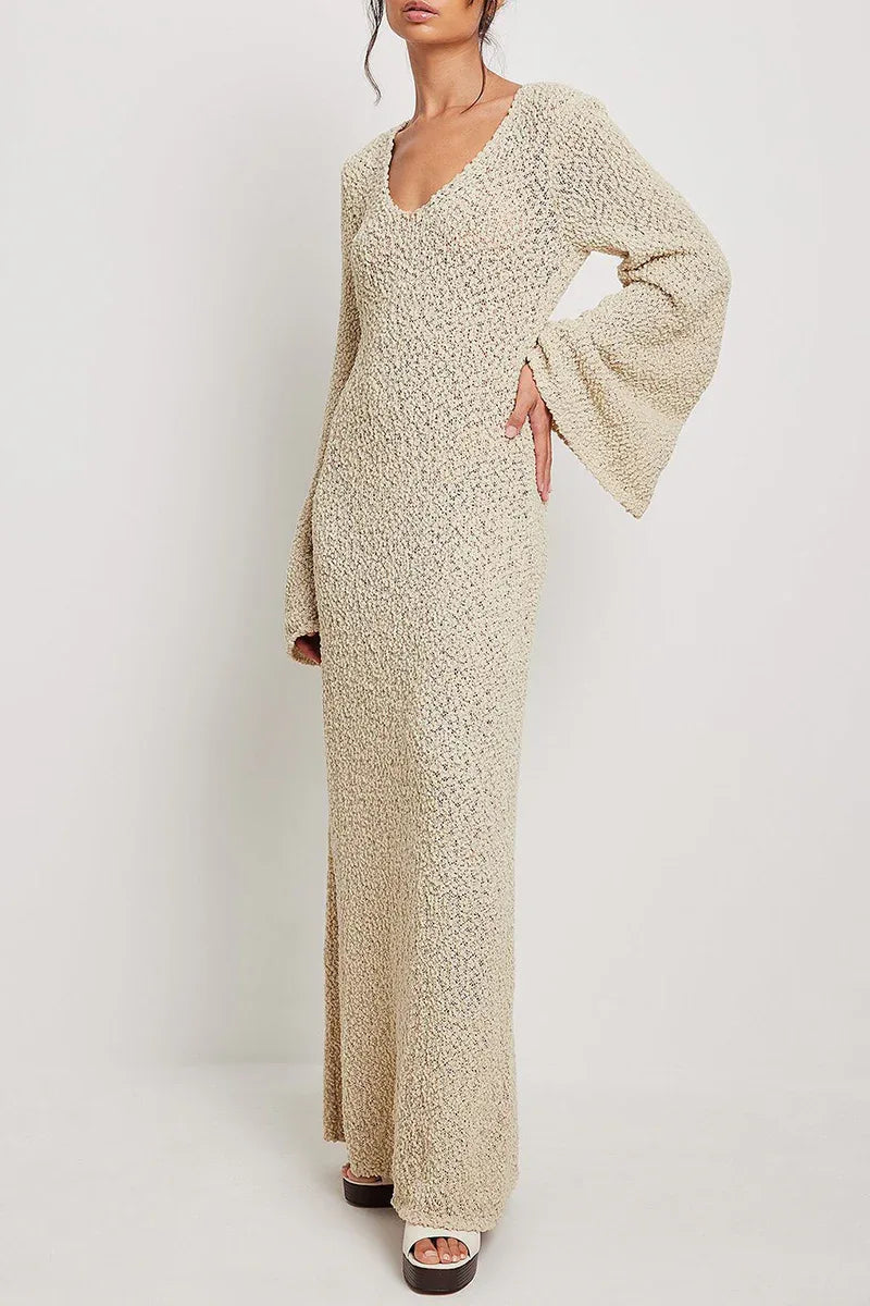 full body shot of a woman in a cream textured knit maxi dress with long bell sleeves and a v-neckline