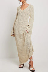 woman wearing a cream textured knit maxi dress with long bell sleeves and a v-neckline, paired with platform sandals
