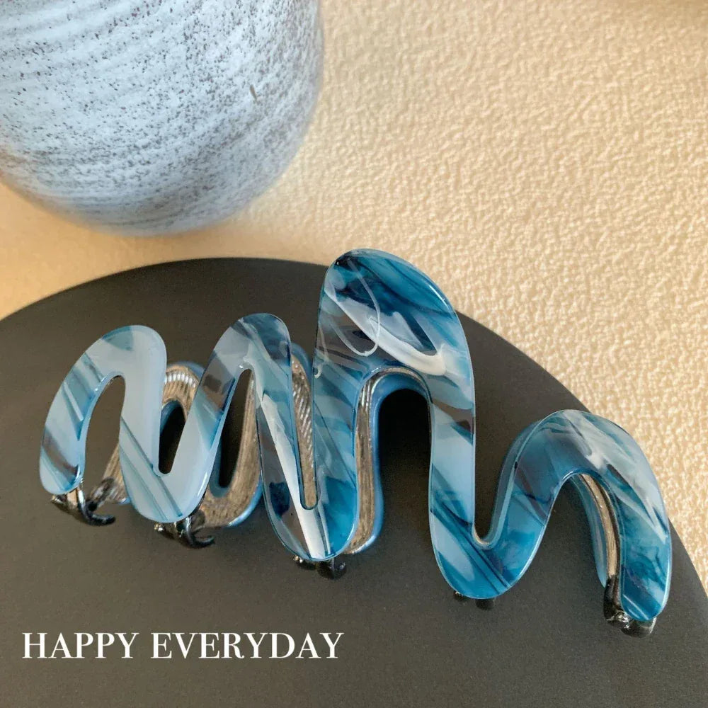 Modern abstract blue and grey marble acetate hair claw clip with a bow silhouette - View 9 | TEVQA