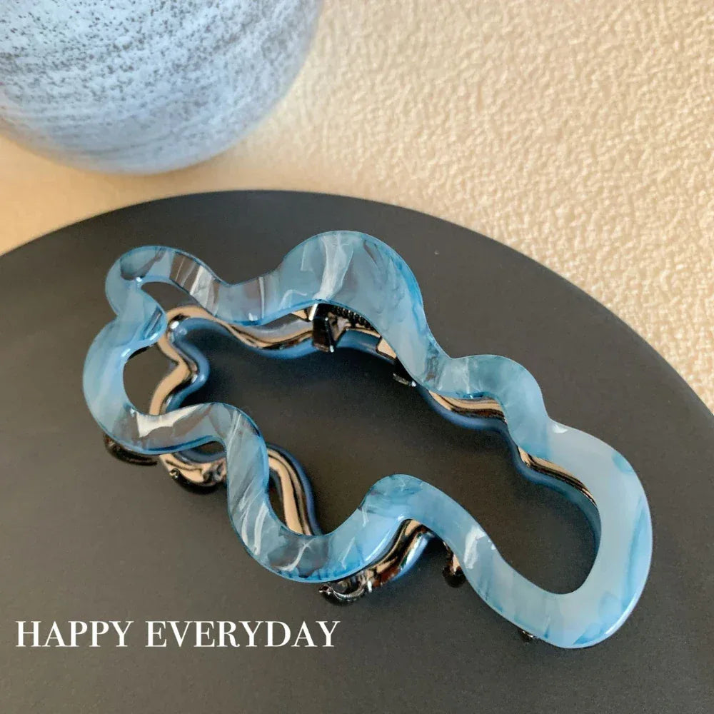 Modern abstract blue and grey marble acetate hair claw clip with a bow silhouette - View 7 | TEVQA