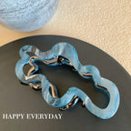 Modern abstract blue and grey marble acetate hair claw clip with a bow silhouette - View 7 | TEVQA
