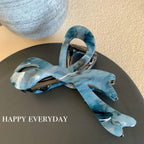 Modern abstract blue and grey marble acetate hair claw clip with a bow silhouette - View 8 | TEVQA