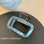 close-up of a blue marbled rectangular hair claw