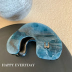 Modern abstract blue and grey marble acetate hair claw clip with a bow silhouette - View 12 | TEVQA