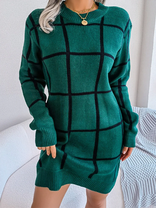 Woman wearing a green and black plaid knit sweater dress