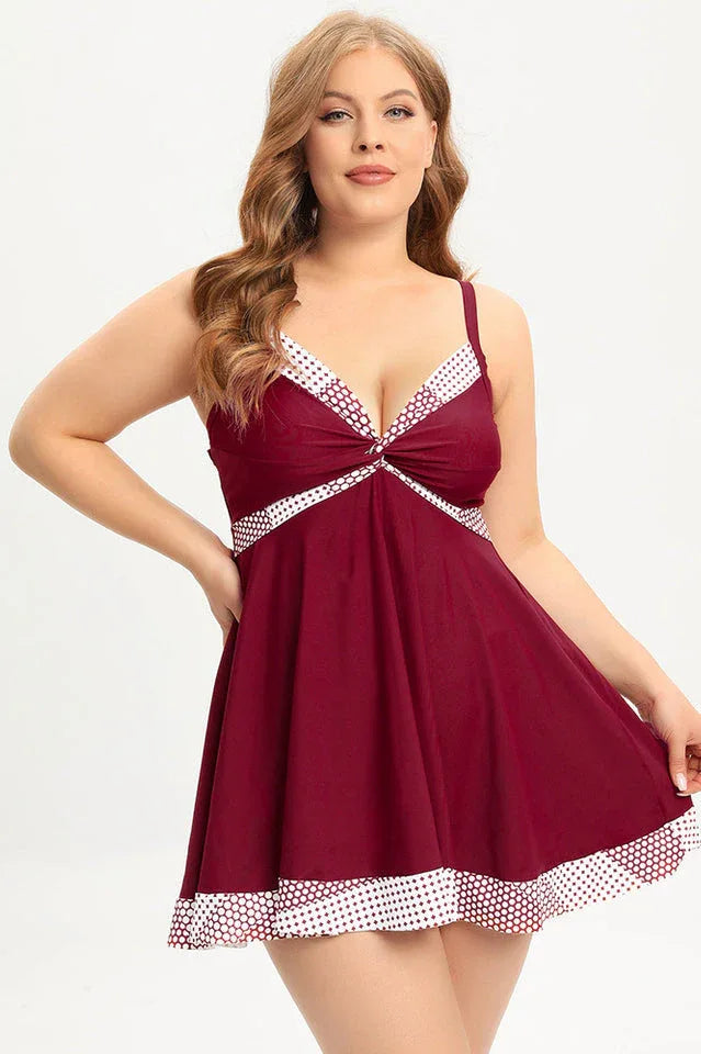 Plus-size burgundy swim dress with polka dot trim and twisted front Main image