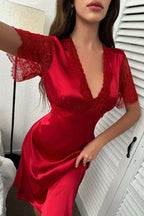 Close-up of a red satin nightgown with V-neckline and lace sleeves